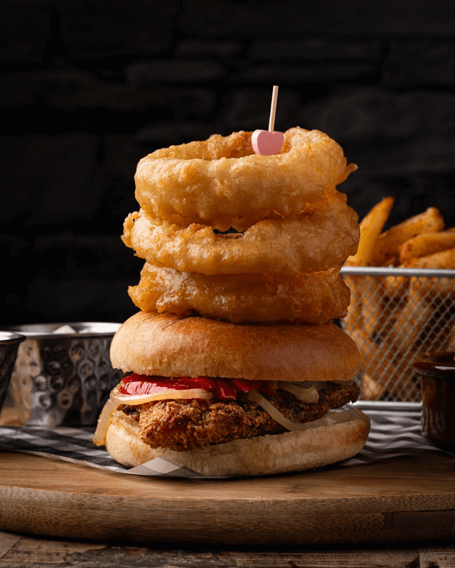 Chicken burger with stacked onion rings