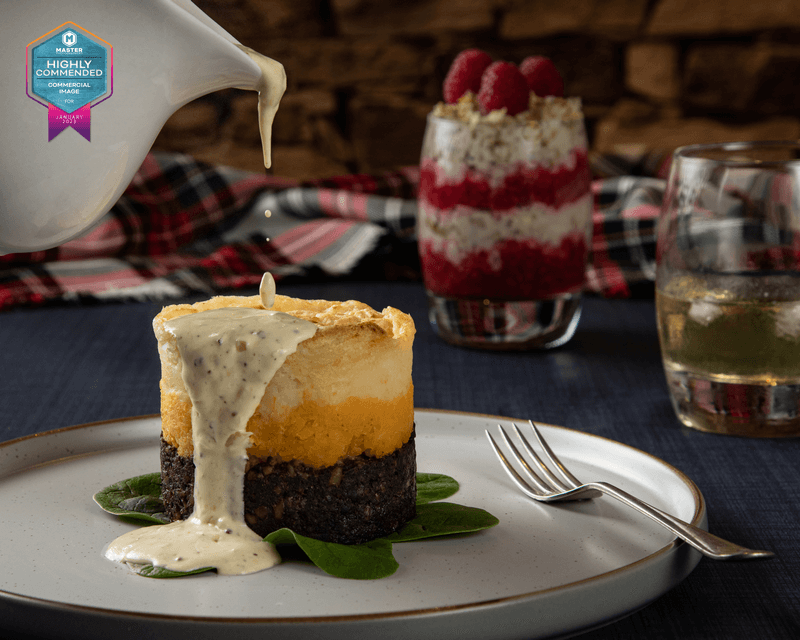 Haggis neeps and tatties with sauce being poured over